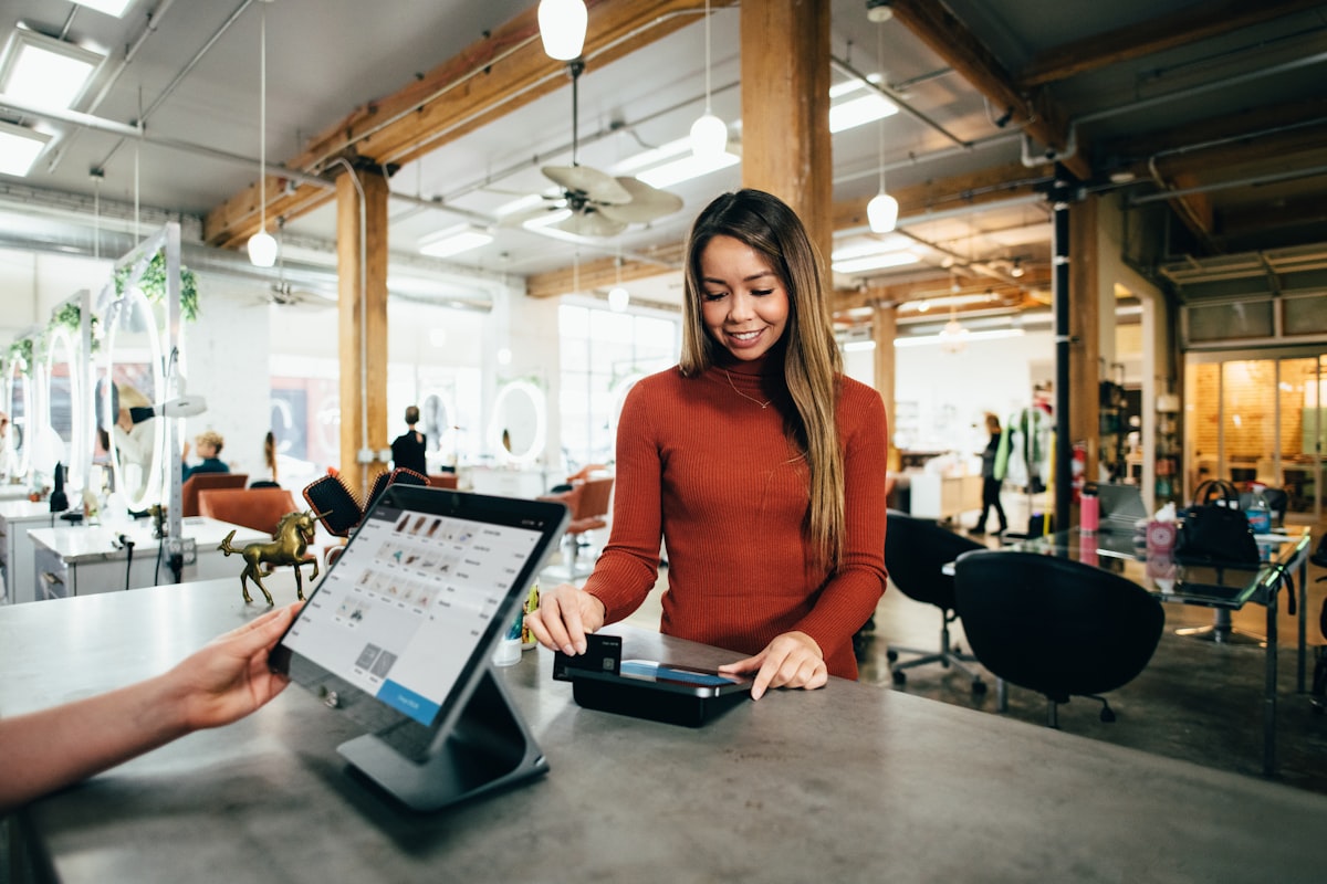 Small business owner running her shop, posting to social media in seconds